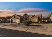 Single-story home with attached garage and landscaped front yard at 15220 W Blue Verde Dr, Sun City West, AZ 85375