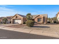 One-story home with a two-car garage and desert landscaping at 15220 W Blue Verde Dr, Sun City West, AZ 85375