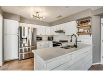 Modern kitchen with white cabinets, stainless steel appliances, and a bright countertop at 16625 N Agate Knoll Pl, Fountain Hills, AZ 85268