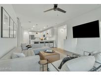 Bright living room with sectional sofa and kitchen view at 1671 E Dogwood Ln, Gilbert, AZ 85295