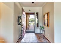 Bright entryway with decorative rug and view to backyard at 18187 W Wind Song Ave, Goodyear, AZ 85338