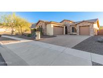 Beautiful stone elevation home with three car garage and desert landscaping at 213 E Summerside Rd, Phoenix, AZ 85042