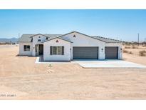 Charming single-story home with a three-car garage, desert landscaping, and a neutral color palette at 25505 W Brookhart Way, Wittmann, AZ 85361