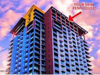 Exterior view of a modern high-rise building with blue and yellow accents and clear glass windows at 310 S 4Th St # 2202, Phoenix, AZ 85004