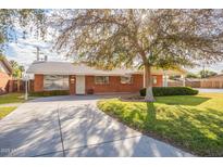 Brick ranch home with a large yard and driveway at 3249 W Maryland Ave, Phoenix, AZ 85017