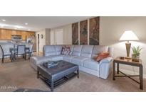 Open living area showcasing a contemporary sectional sofa and adjacent dining area at 4704 E Paradise Village N Pkwy # 239, Phoenix, AZ 85032