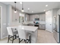 Modern kitchen with white quartz countertops and gray cabinets at 518 E Balao Dr, Phoenix, AZ 85085