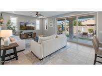 Bright living room with sliding glass doors leading to a backyard oasis at 518 E Balao Dr, Phoenix, AZ 85085