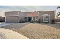 Single-story home with a two-car garage and desert landscaping at 5821 W Kesler St, Chandler, AZ 85226