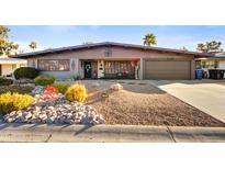 Attractive ranch-style home with landscaped front yard and two-car garage at 723 S Edgewater Dr, Mesa, AZ 85208