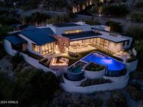 Luxury home with pool and mountain views at night at 7537 N Lakeside Ln, Paradise Valley, AZ 85253