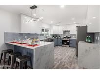 Modern kitchen with stainless steel appliances and an island at 1152 W Greenway Dr, Tempe, AZ 85282