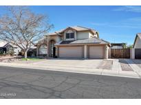 Two-story house with three-car garage and solar panels at 11553 N 76Th Dr, Peoria, AZ 85345