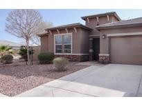 One-story home with a two-car garage and desert landscaping at 12075 E Chevelon Trl, Gold Canyon, AZ 85118