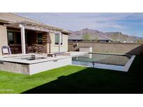 Relaxing backyard oasis with a sparkling pool, spa, and mountain views at 12075 E Chevelon Trl, Gold Canyon, AZ 85118