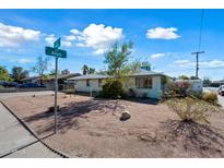 Ranch style home with a flat roof and desert landscaping at 1231 E Vine Ave, Mesa, AZ 85204