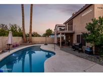 Inviting kidney-shaped pool with patio and grilling area at 1540 W Orchid Ln, Chandler, AZ 85224