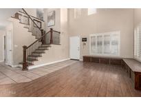 Spacious entryway with hardwood floors and a built-in bench at 1540 W Orchid Ln, Chandler, AZ 85224