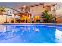 Inviting backyard pool with a well-maintained patio, outdoor dining, and second story balcony at 1540 W Orchid Ln, Chandler, AZ 85224