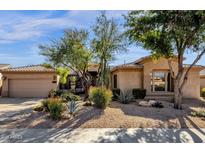 Desert landscaping surrounds this inviting single-story home with a two-car garage at 21893 N 78Th St, Scottsdale, AZ 85255