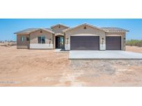Charming single-story home with a two-car garage, desert landscaping and neutral color palette at 21916 W Duane Ln, Wittmann, AZ 85361