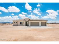 An inviting single-story home with a neutral color scheme and a spacious three-car garage at 25519 W Brookhart Way, Wittmann, AZ 85361