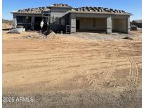 New construction home with a two-car garage and desert landscaping at 29577 N 220Th Ave, Wittmann, AZ 85361