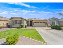 Tan single-story home with a well-manicured lawn, stone accents, and a two-car garage at 3383 E Santa Fe Ln, Gilbert, AZ 85297