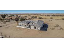 Aerial view of a single-story home with a large backyard and desert landscape at 34150 W Corleone Dr, Maricopa, AZ 85138