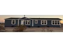 Single story home with blue exterior and white trim at 38007 W Mcdowell Rd, Tonopah, AZ 85354