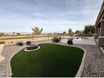 Artificial turf backyard with fire pit and pool at 3888 E Hazeltine Way, Chandler, AZ 85249