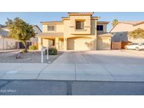 Two-story house with a three-car garage and desert landscaping at 4340 E Silverbell Rd, San Tan Valley, AZ 85143