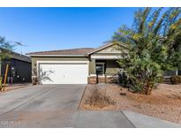 Single-story house with a white garage door and landscaping at 4718 N 193Rd Dr, Litchfield Park, AZ 85340