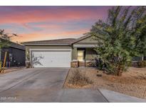 One-story home with a two-car garage and desert landscaping at 4718 N 193Rd Dr, Litchfield Park, AZ 85340