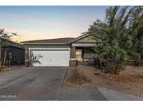 One-story home with a two-car garage and desert landscaping at 4718 N 193Rd Dr, Litchfield Park, AZ 85340