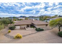 Single-story home with a large yard and mountain views at 4805 W Saguaro Park Ln, Glendale, AZ 85310