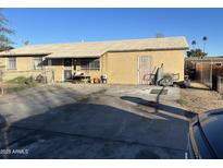 Ranch style home with a large front yard and driveway at 5616 W Granada Rd, Phoenix, AZ 85035