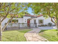 Charming single-story home featuring a red tile roof, well-kept lawn, and a quaint stone pathway leading to the front door at 701 W Cambridge Ave, Phoenix, AZ 85007