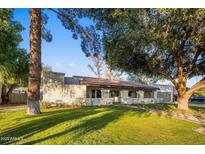 Single-story home with a red tile roof, landscaping, and a large tree in the front yard at 8614 E Appaloosa Trl, Scottsdale, AZ 85258