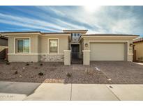 Single-story home with a two-car garage and landscaped front yard at 11005 E Texas Ave, Mesa, AZ 85212