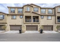 Tan three-story townhome with three-car garage and balcony at 1255 N Arizona Ave # 1341, Chandler, AZ 85225