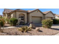 Attractive desert landscape surrounds this charming two-story home with a two-car garage at 1577 E Laurel Dr, Casa Grande, AZ 85122