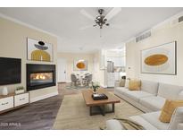 Inviting living room boasts a cozy fireplace, neutral tones, and flows into dining and kitchen at 1701 E Colter St # 223, Phoenix, AZ 85016