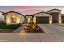 Inviting desert home showcasing professional landscaping, charming accents, and a paver driveway at 22901 E Quintero Rd, Queen Creek, AZ 85142