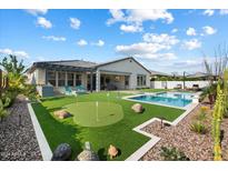 Luxury backyard oasis with putting green, pool, and pergola at 3015 E Daley Ln, Phoenix, AZ 85050