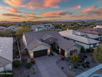 Luxury home with desert landscaping, expansive driveway, and mountain views at sunset at 30224 N 52Nd Pl, Cave Creek, AZ 85331