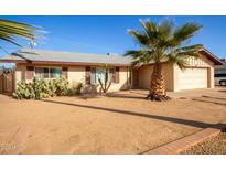 Single story home with desert landscaping and a two-car garage at 4028 W Palo Verde Dr, Phoenix, AZ 85019