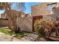 Attractive stucco condo exterior with gated entry and landscaping at 4240 N 67Th Ln, Phoenix, AZ 85033