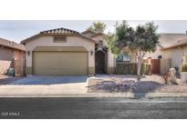 Single-story house with a two-car garage and desert landscaping at 45091 W Cypress Ln, Maricopa, AZ 85139