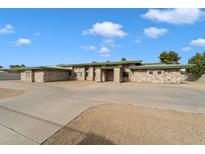 Stunning stone facade, expansive driveway, and a well-manicured lawn at 5540 E Shea Blvd, Scottsdale, AZ 85254